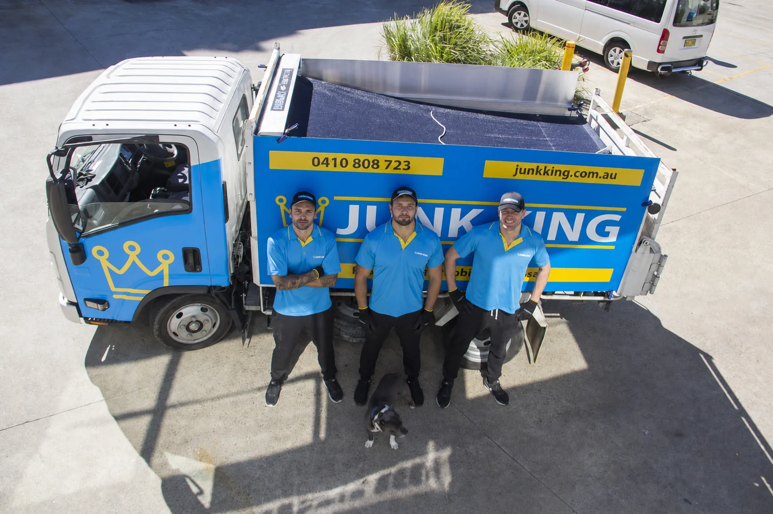 Junk King Sydney crew standing with the branded truck after a local job
