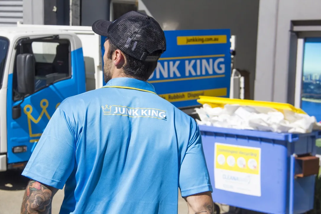Junk King crew member near rubbish bins and truck