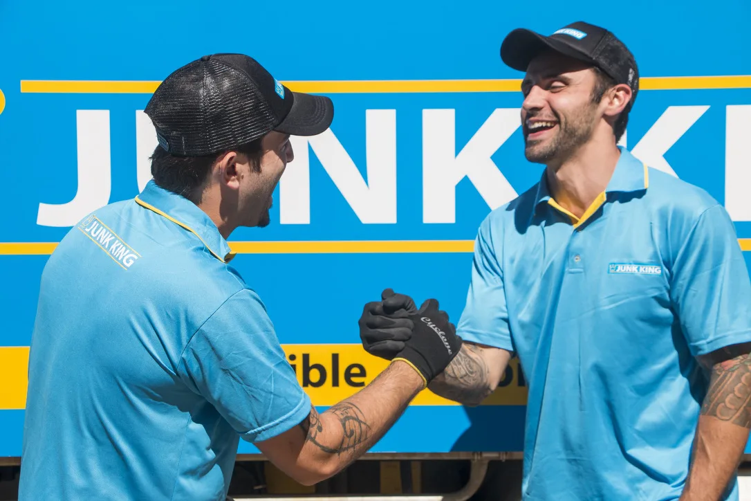 Junk King Sydney crew smiling in front of a branded truck