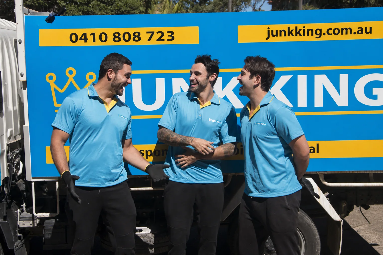 Three Junk King Sydney crew members beside the branded truck