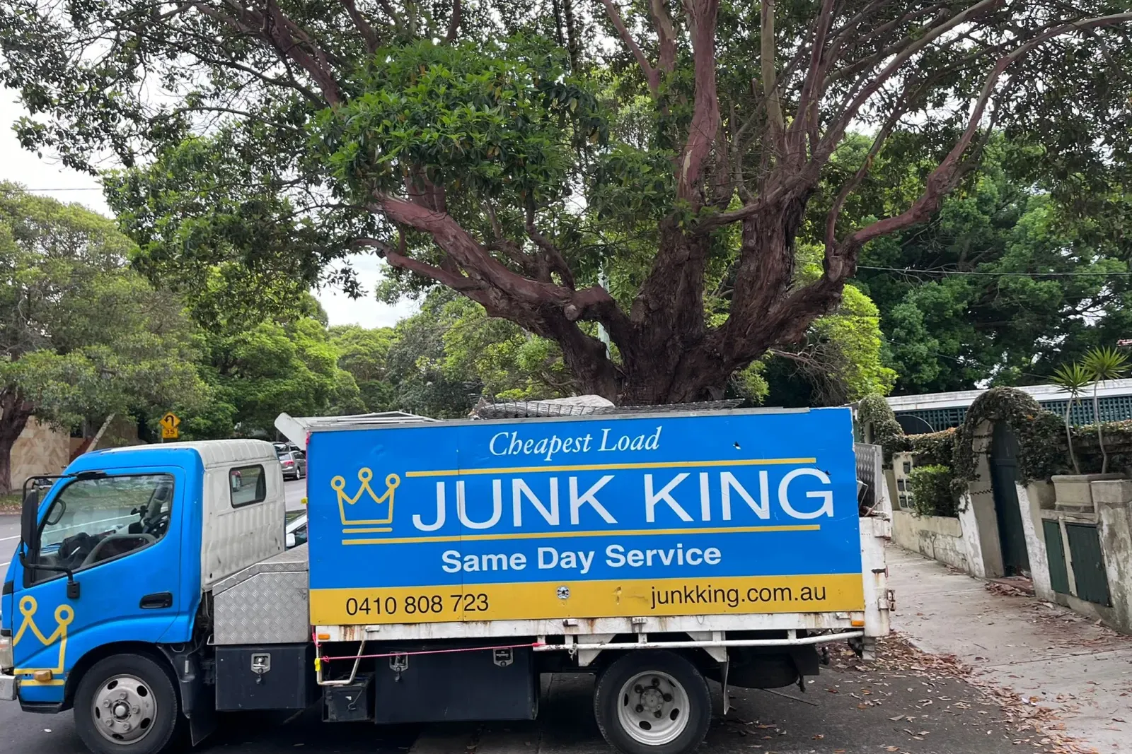 Junk King truck on a leafy Sydney street for a garden waste and green waste pickup