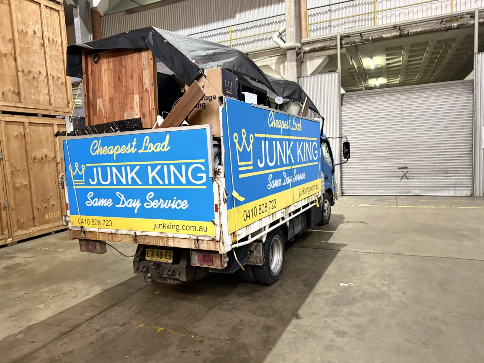 Junk King truck loaded with furniture and bulky rubbish at a warehouse pickup