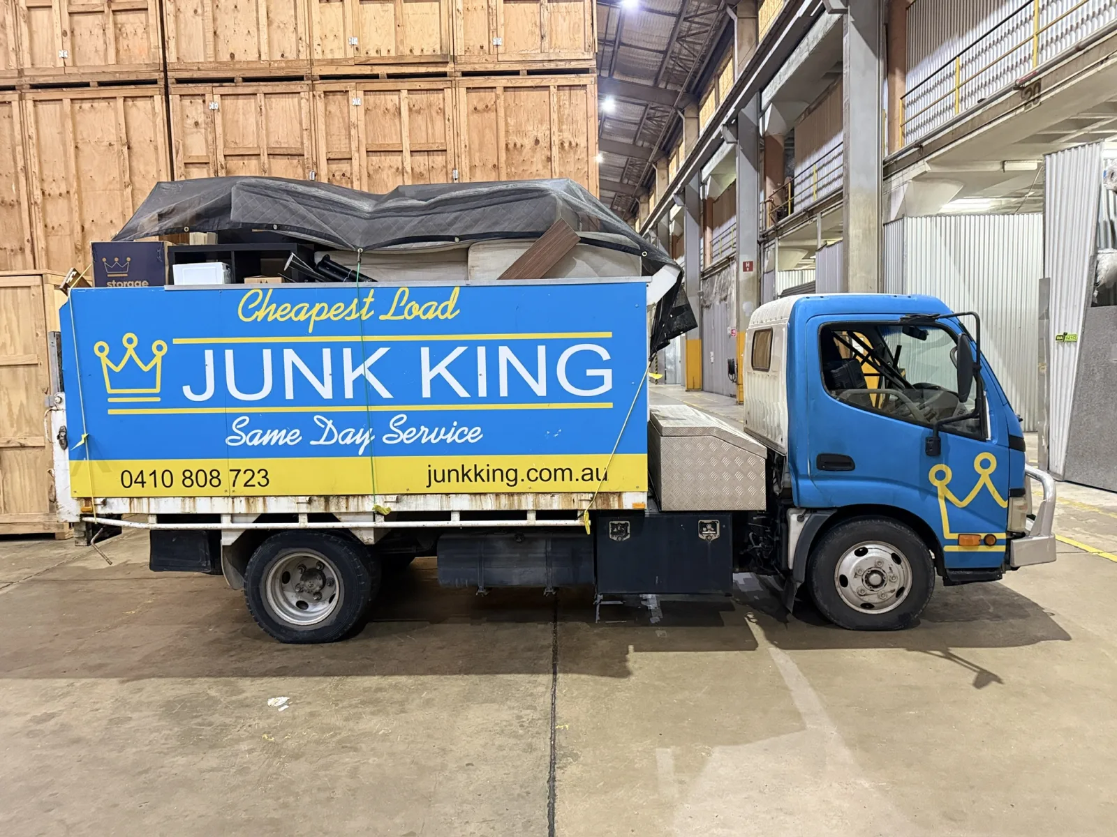 Junk King rubbish removal truck loaded with a secured mixed load