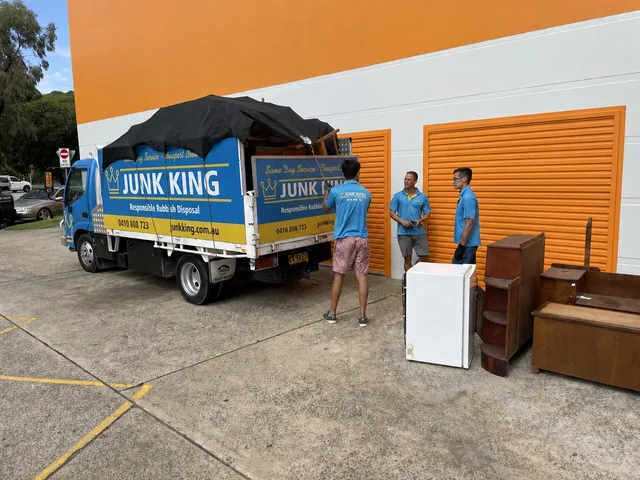 Junk King crew beside a loaded truck at a storage cleanout
