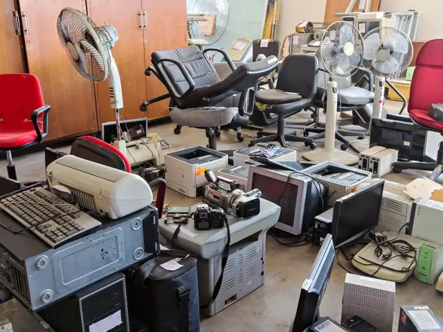 Office chairs and unwanted computer equipment gathered for a workplace clearout